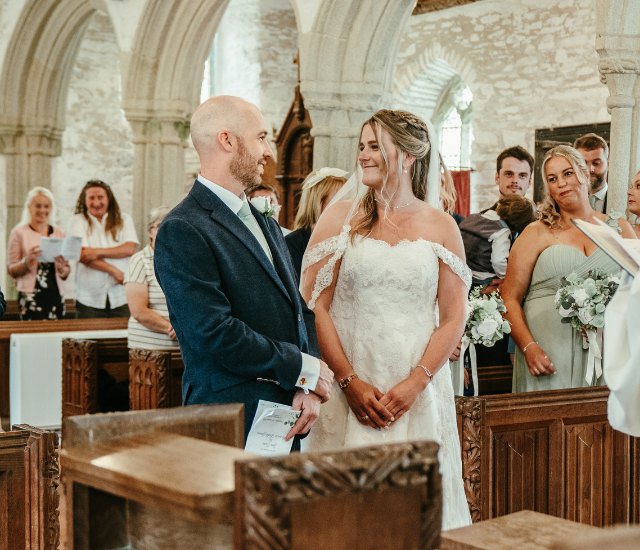 Couple smiling at each other during the ceremony