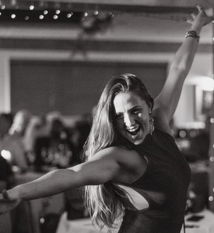 Guest dancing with her arms thrown wide