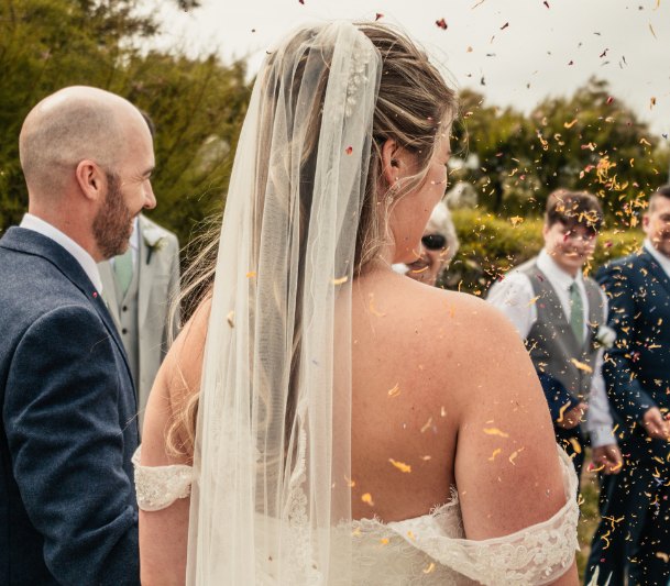 Bride under a shower of petal confetti