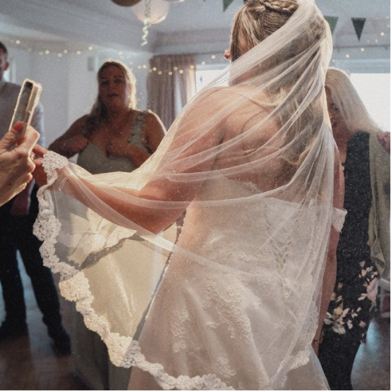 Bride's veil catching the light on the dance floor